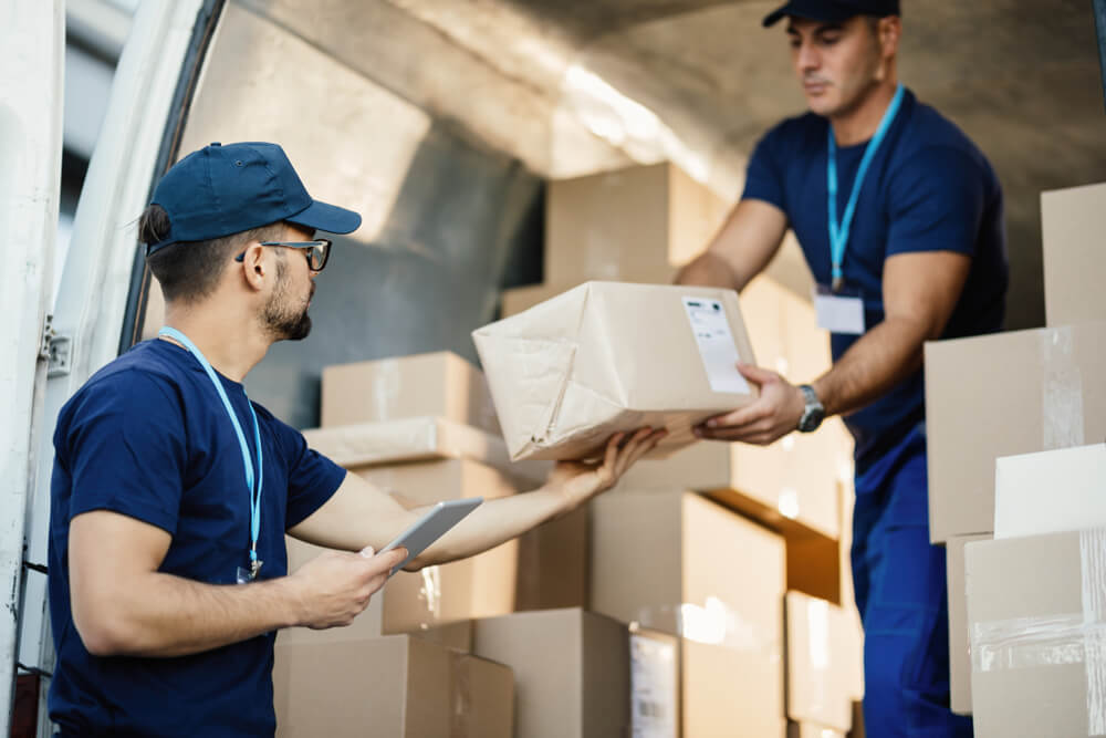 Movers Arranging Boxes Inside A Moving Truck